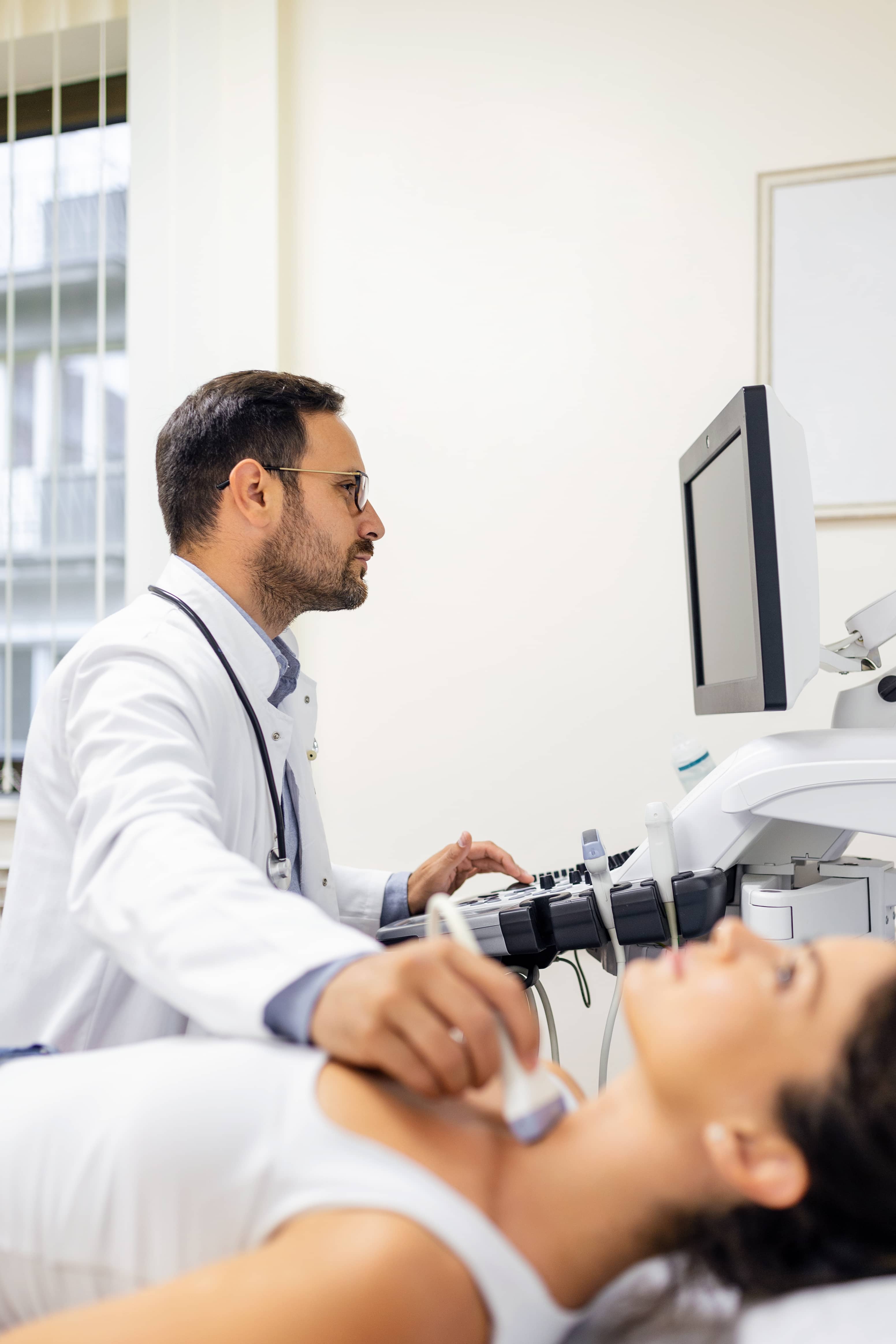 Hombre endocrinólogo haciendo ultrasonografía en Puebla